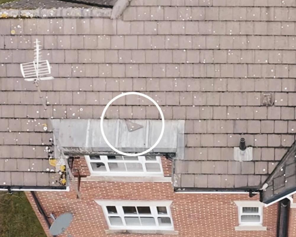 The drone survey shows a loose tile on the apartment block roof